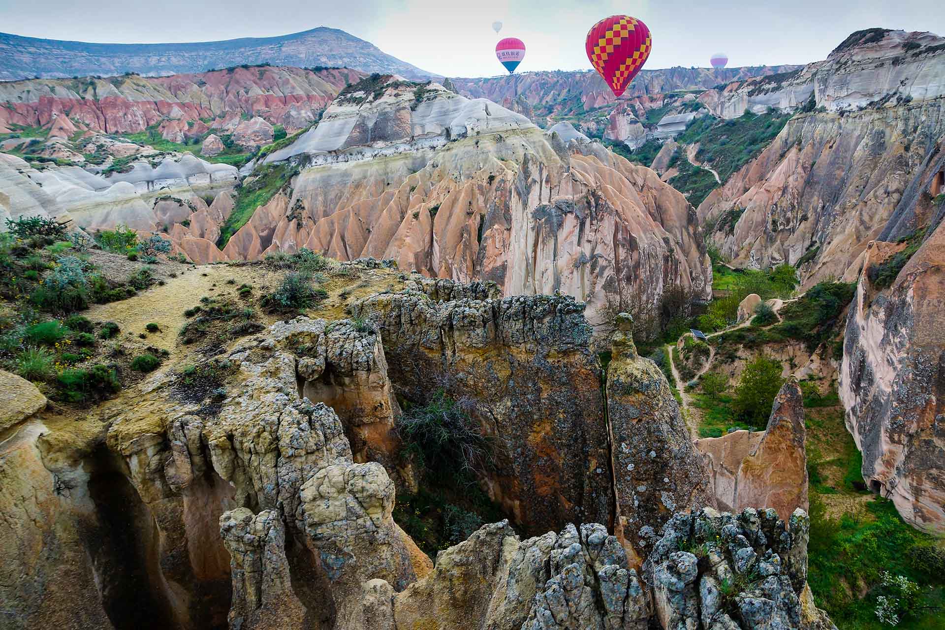 luchtballonnen boven een grillige vallei in Cappadocië